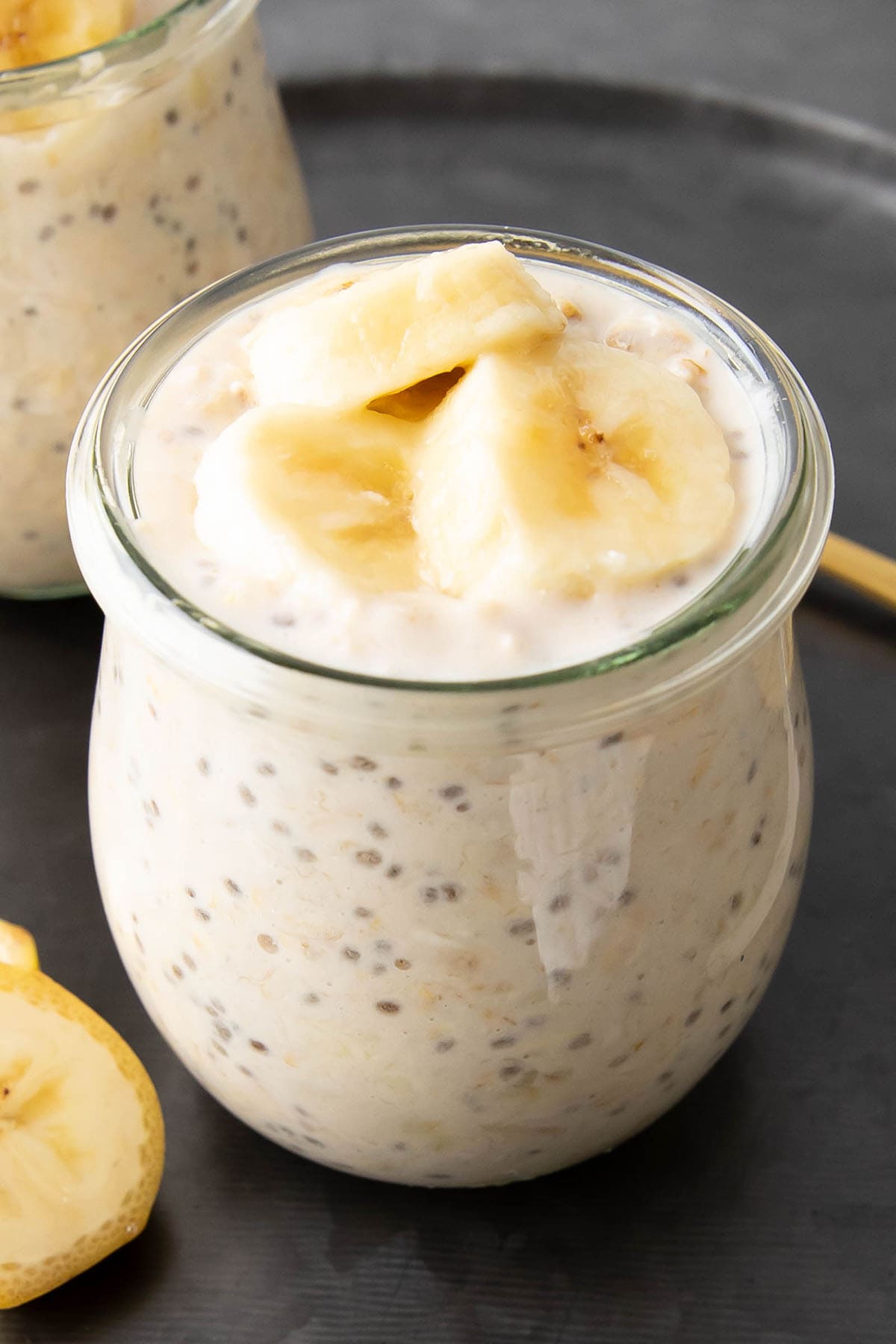close up of a jar of this make-ahead breakfast recipe filled with fruits, chia seeds, and fiber