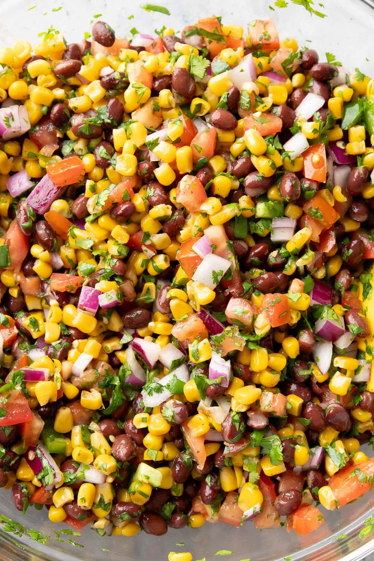 mixing bowl filled with a vegetable side dish of black bean and corn salsa