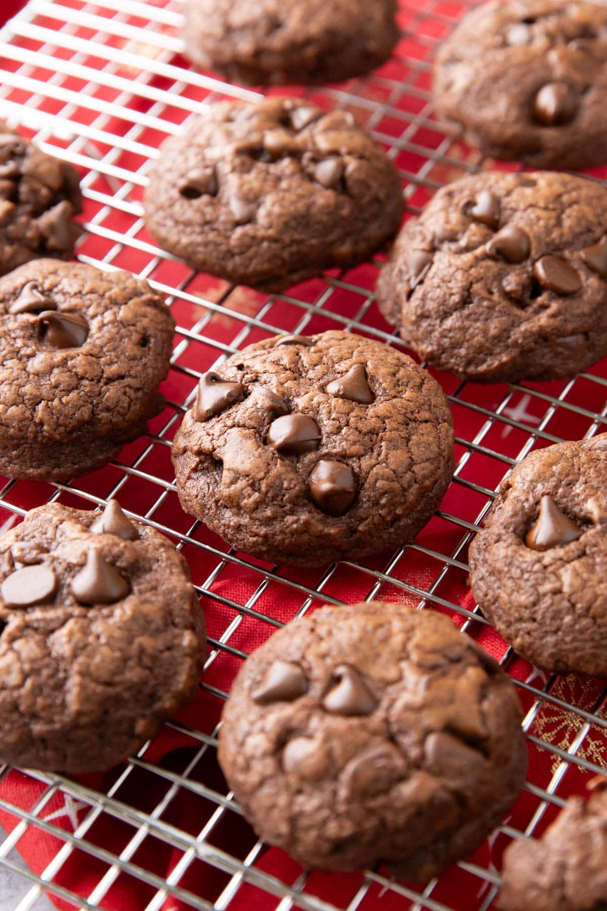 Brownie Cookies on a silver cooling rack over a red napkin