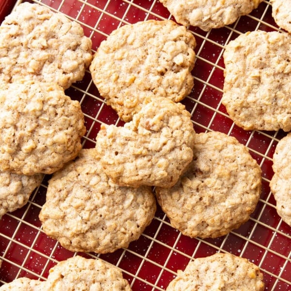 Cinnamon Oatmeal Cookies on a cooling rack tucked into a baking sheet with festive red decorations