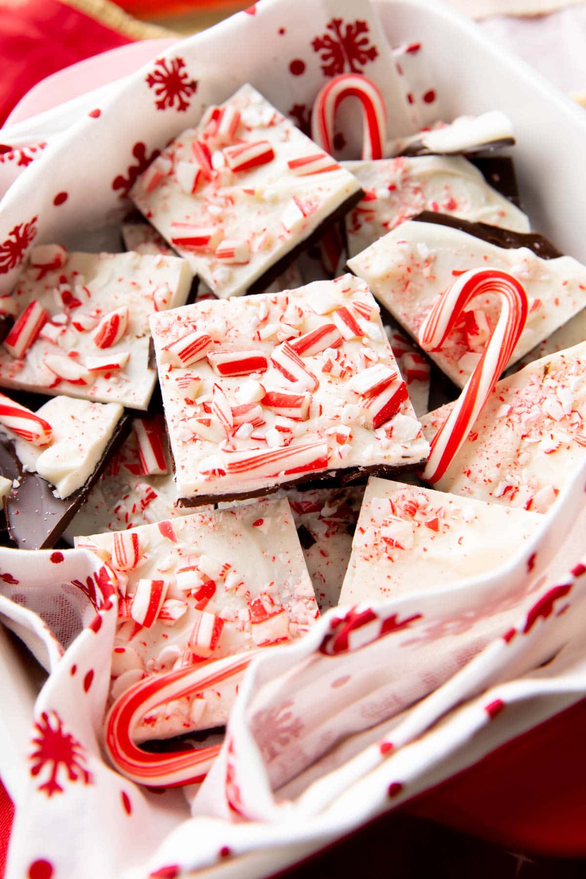 Close up of this peppermint bark recipe to show layers of white and semi-sweet chocolate and crushed candy cane pieces