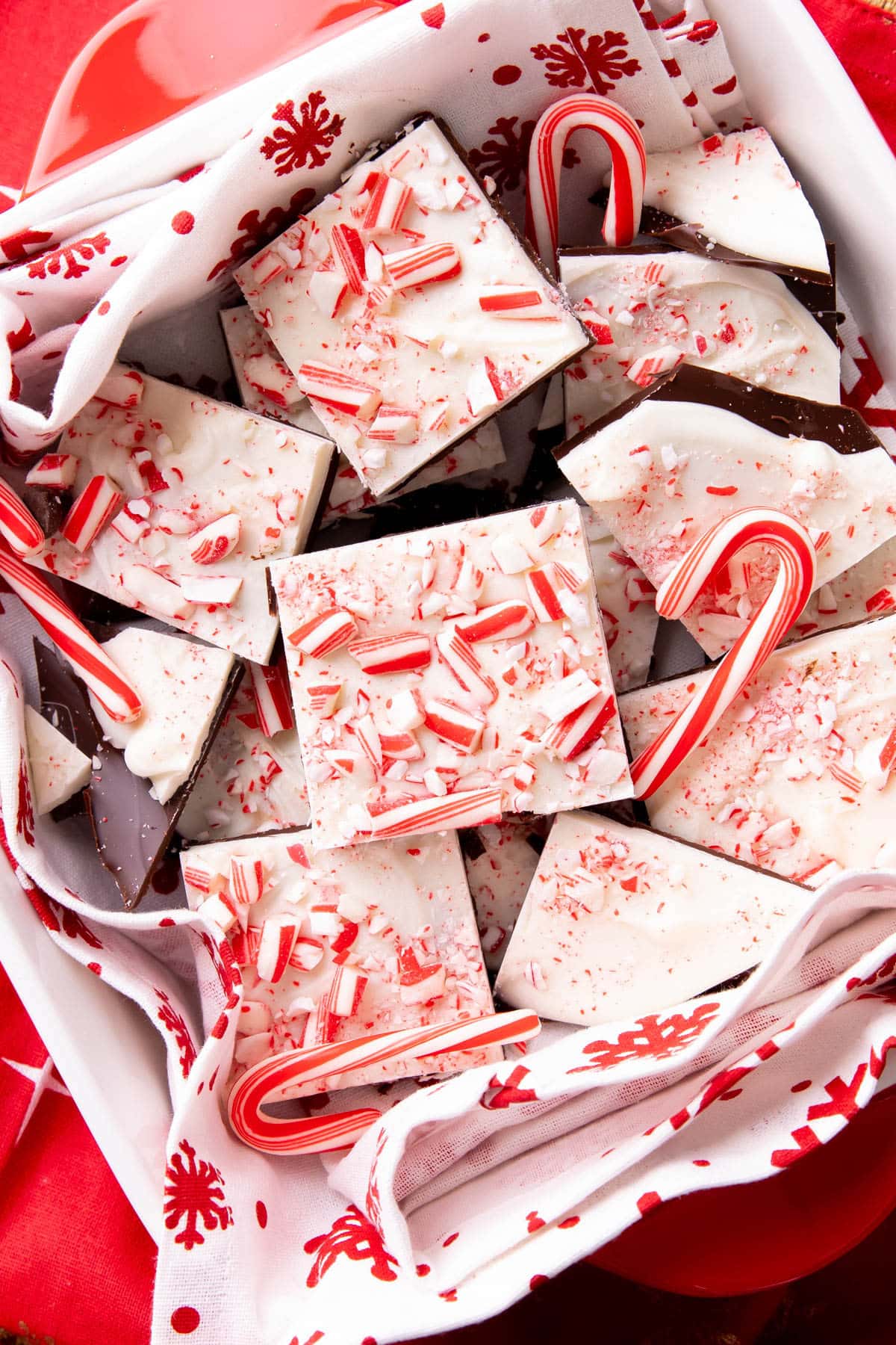Close up of this Peppermint Bark Recipe served in a festive red and white dish with candy canes