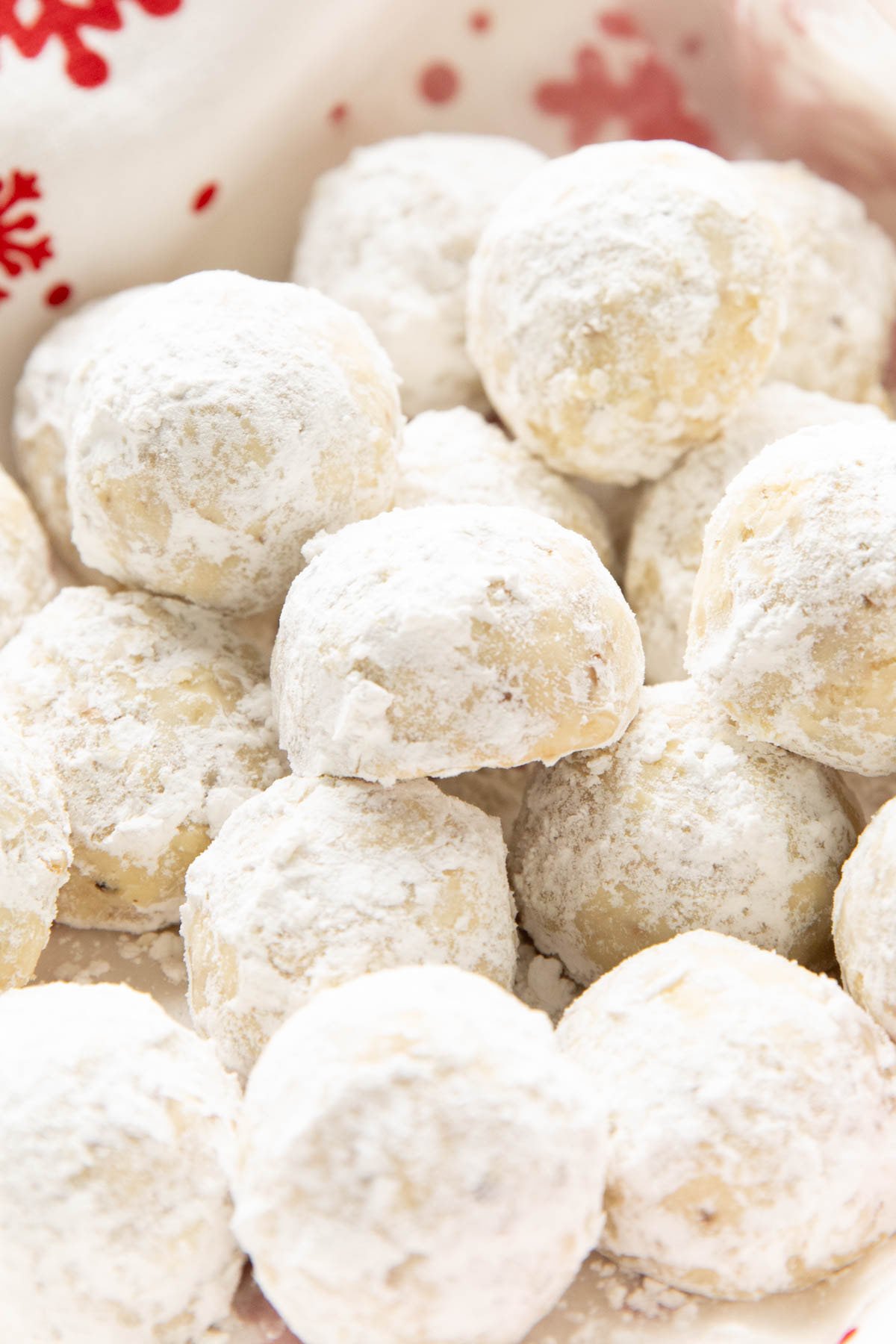 Super close up of holiday treats in a serving tray with powdered sugar and Christmas decorations