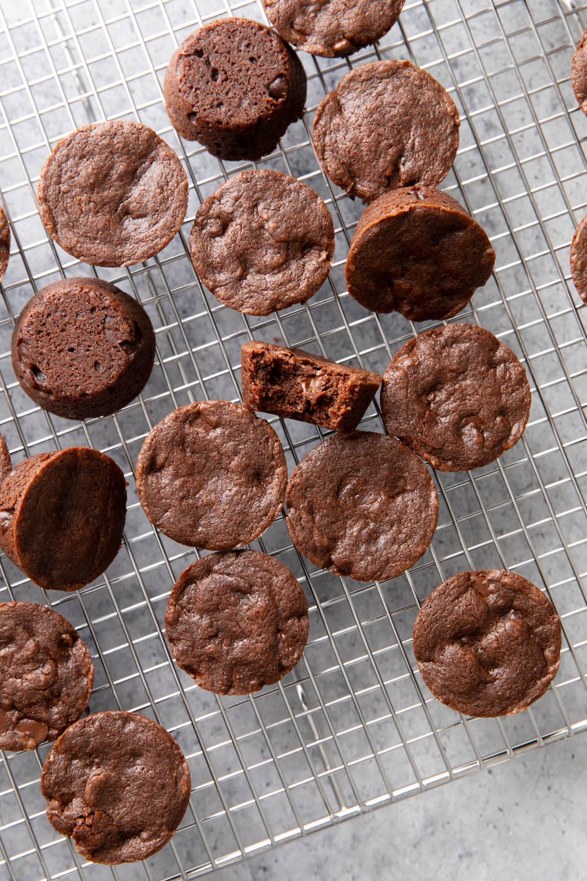 Dozens of Brownie Bites poured onto a cooling rack