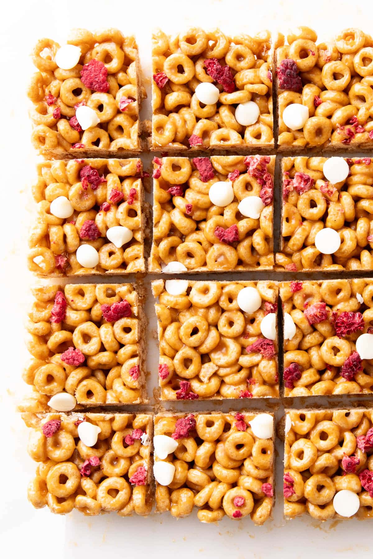 Rows of cereal bars featuring Cheerios topped with dried fruit and chocolate chips