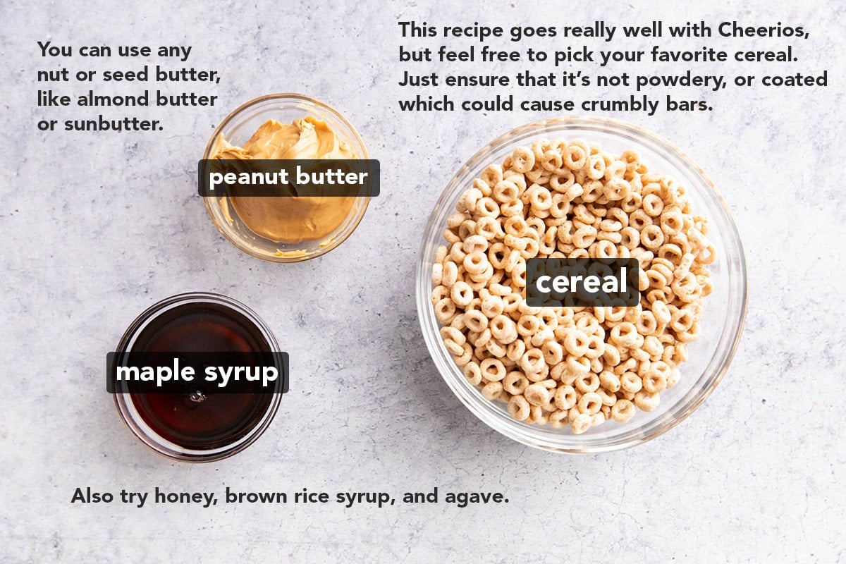 Cereal Bar ingredients measured into bowls, including Cheerios, peanut butter, and maple syrup