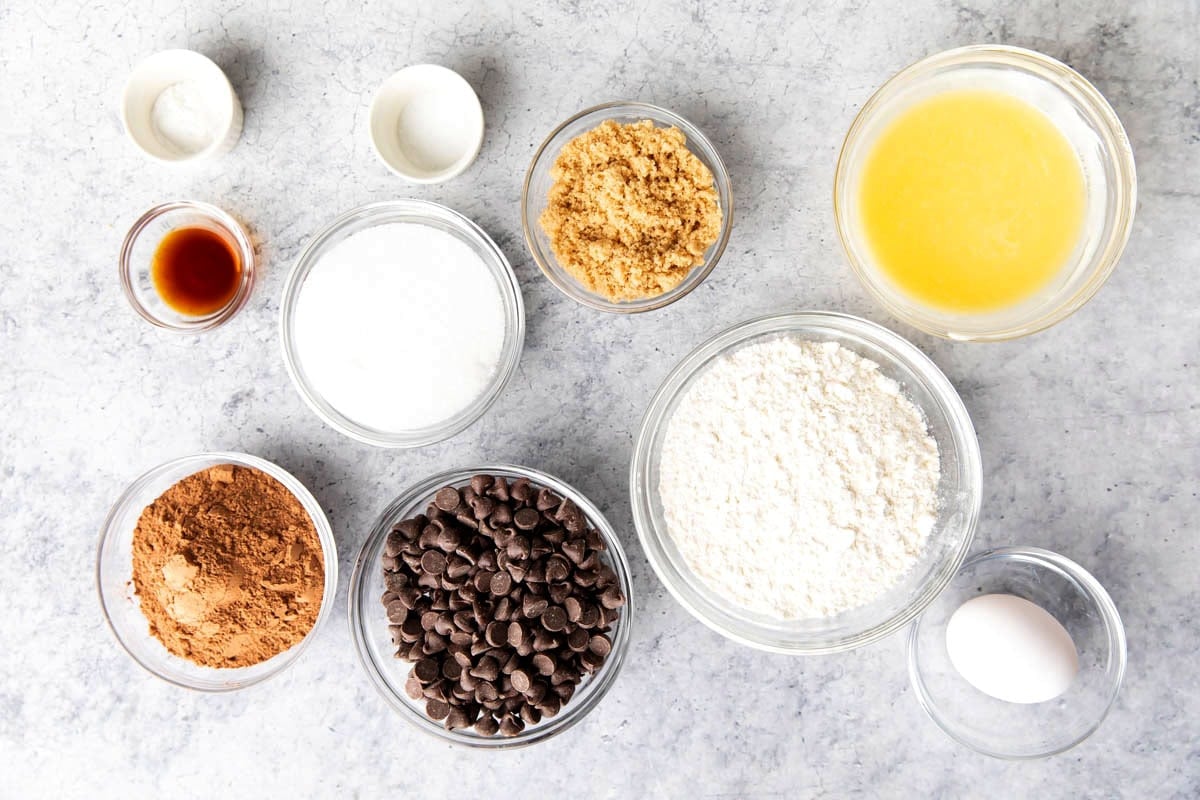 This fudgy brownie bites recipe is made with cocoa powder, flour, chocolate chips, brown sugar, cane sugar, salt, vanilla extract, eggs, butter, and baking powder.