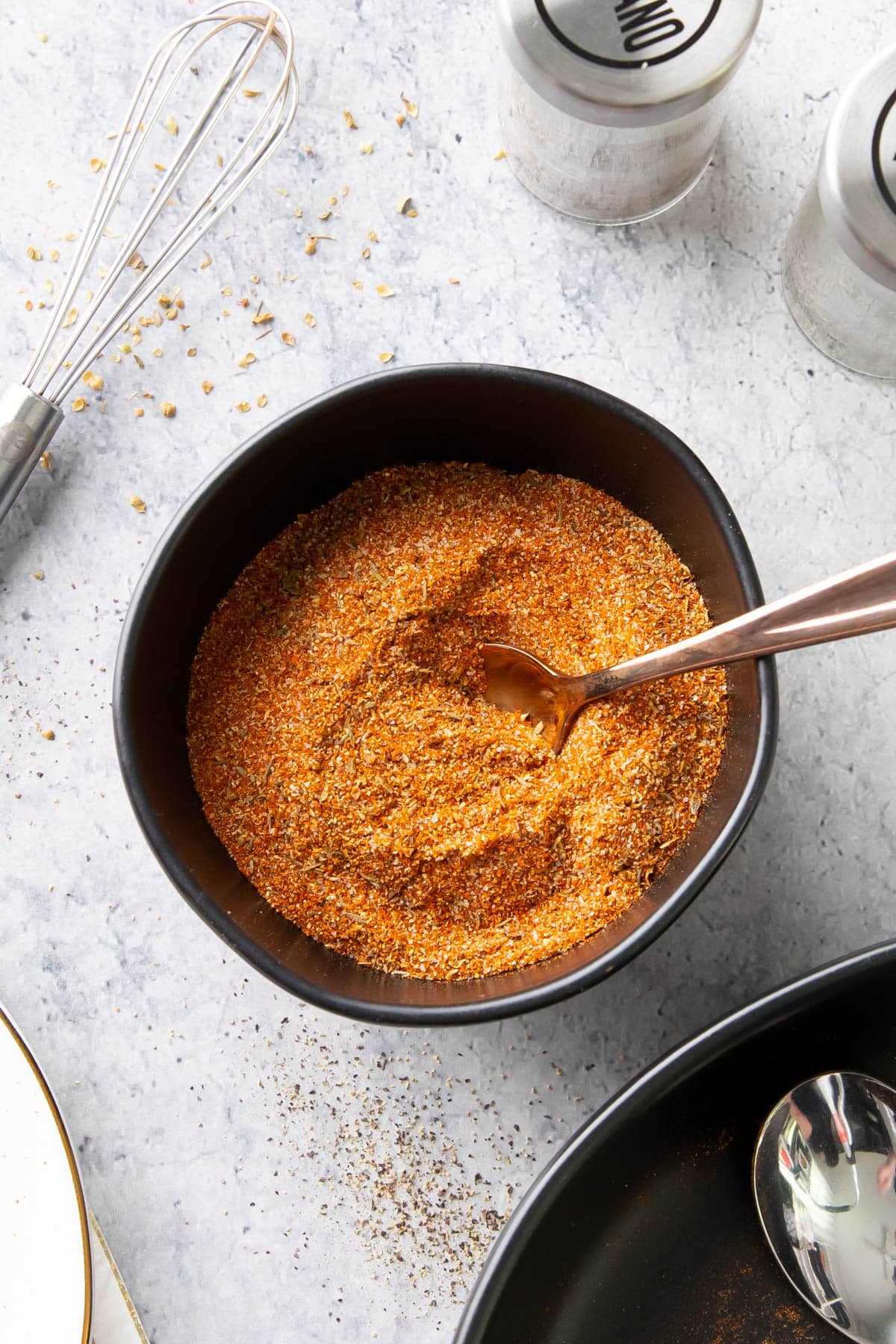 This spicy, flavorful Cajun Seasoning originating from Louisiana served in a bowl with a spoon.
