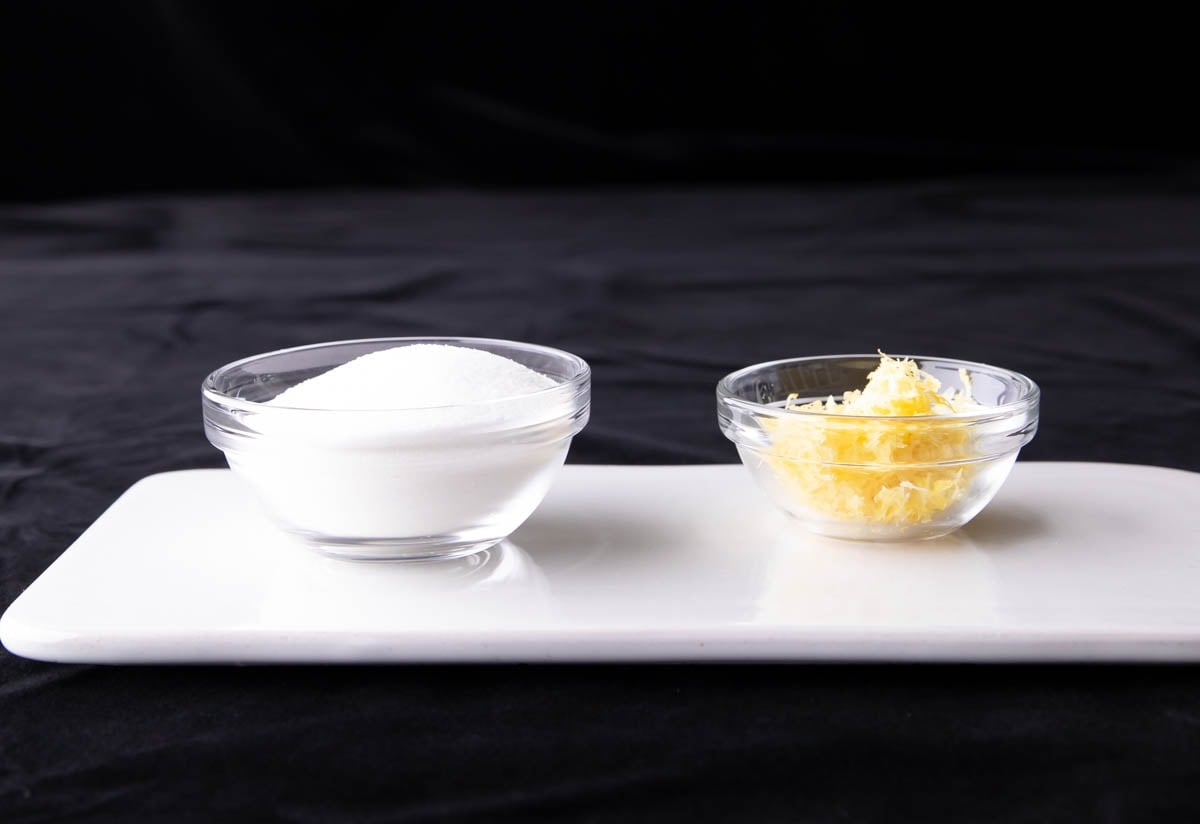 Lemon Sugar ingredients measured into glass prep bowls, including granulated sugar and lemon zest.