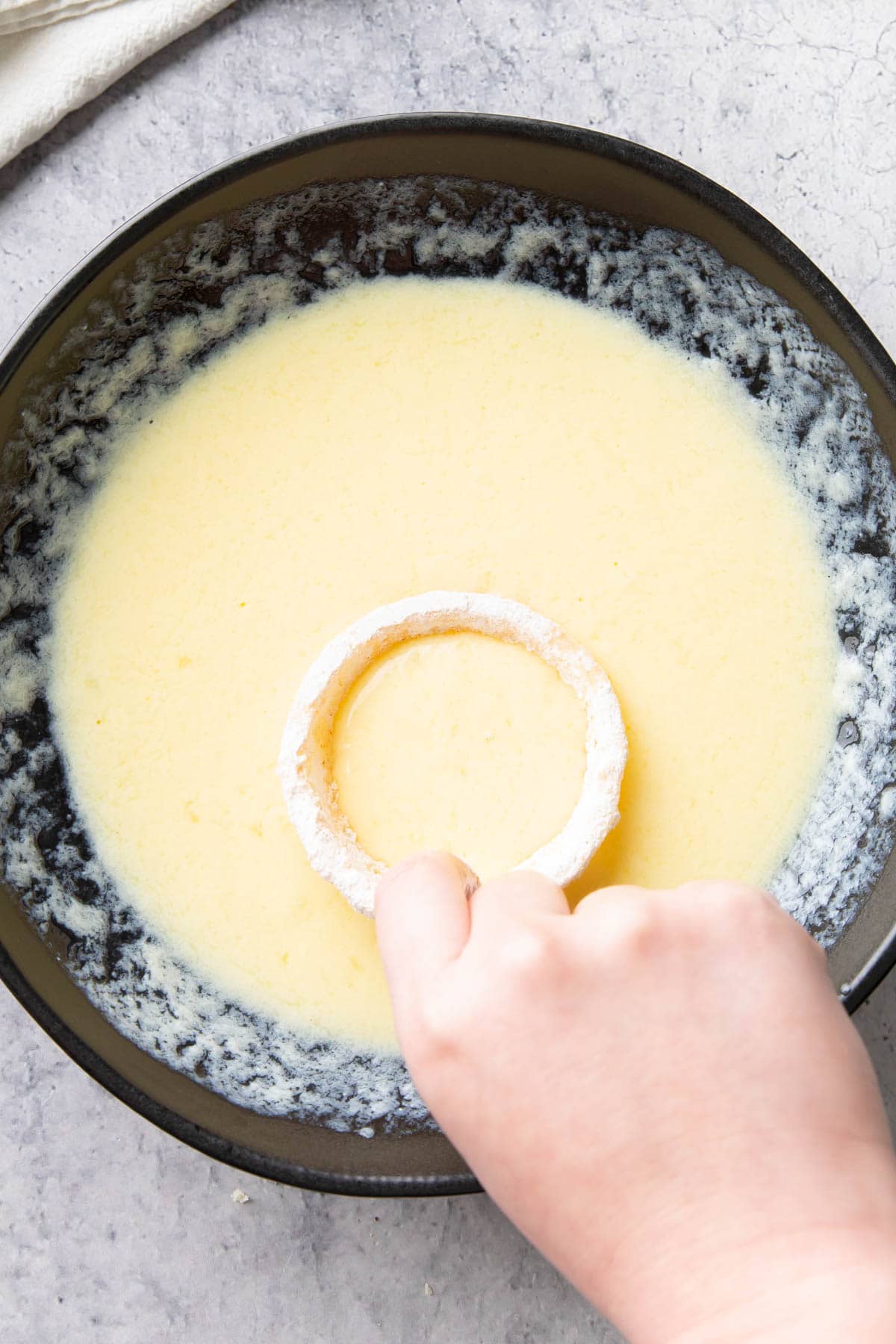 Dipping an onion ring into egg batter