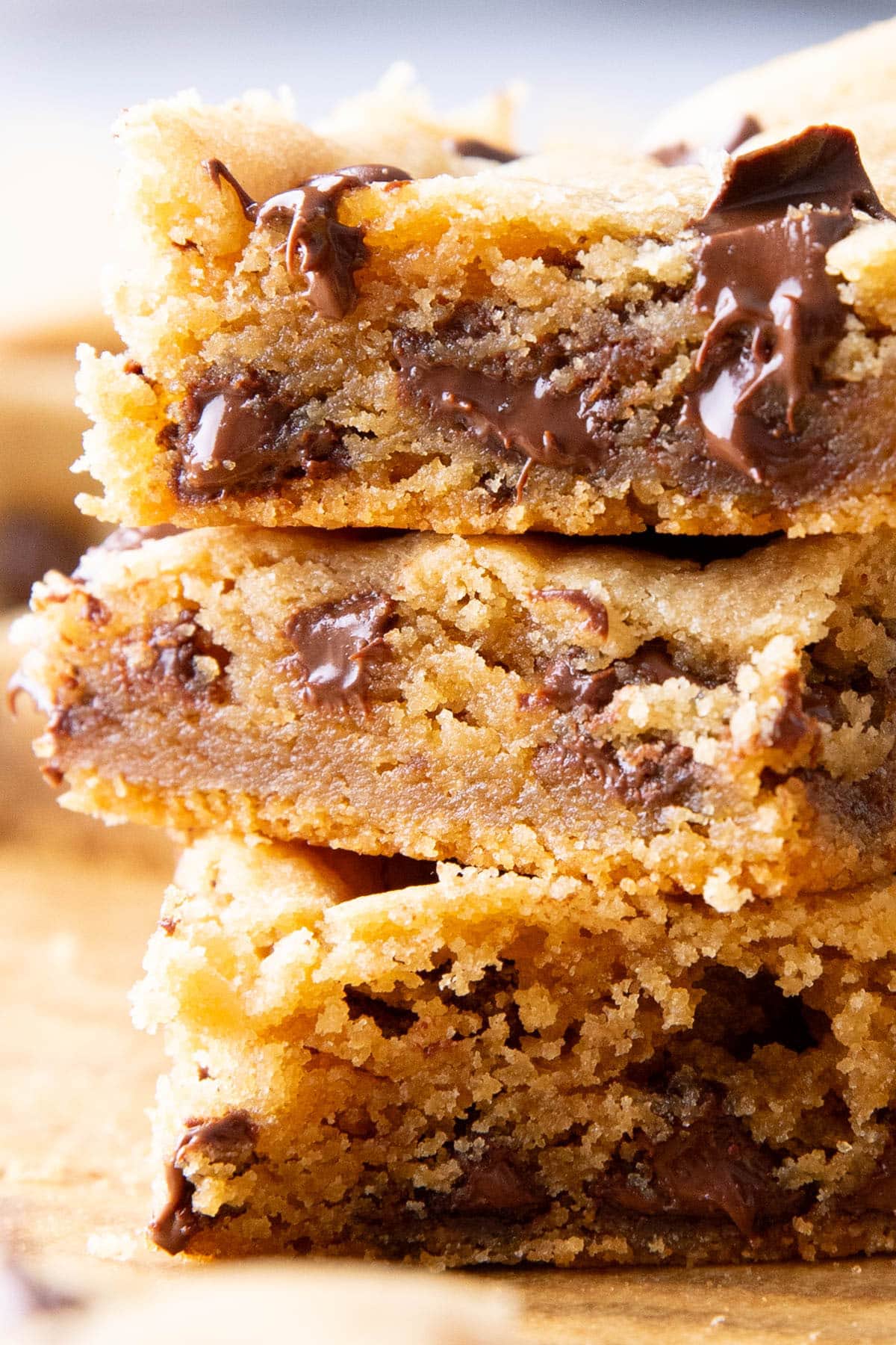 Close up of a stack of dessert bars to showcase chewy, tender texture and add-ins like chocolate chips or Reeses pieces