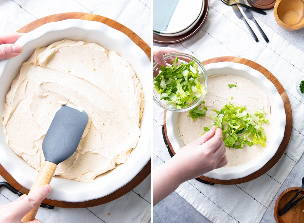 Spreading the seasoned cream cheese layer into the serving dish and topping with shredded lettuce