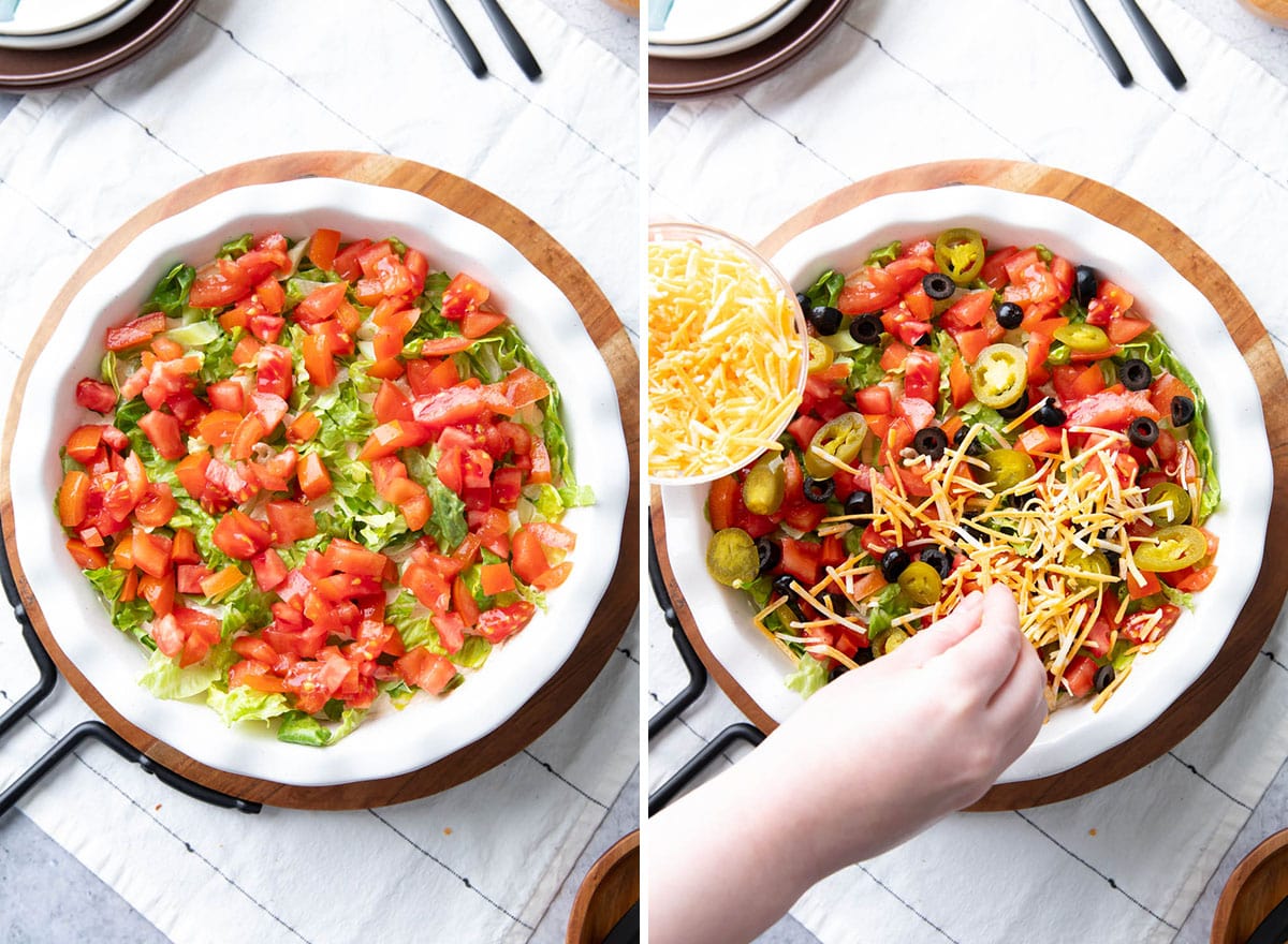 Adding chopped tomatoes, sliced olives, shredded cheese, and other toppings to finish making this taco dip recipe