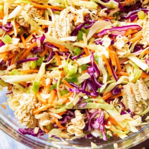 Ramen noodle salad served in a large bowl topped with ramen pieces and asian dressing