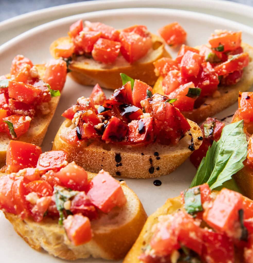 Close up of juicy tomatoes, parmesan, and basil packed bruschetta