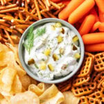 dip bowl filled with creamy dill pickle dip packed with fresh dill