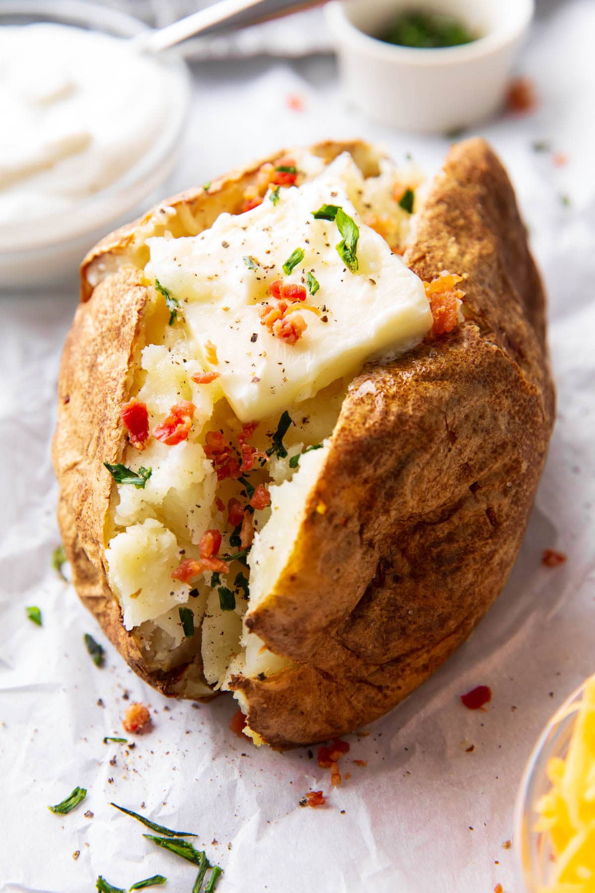 Bacon, butter, and chive topped Air Fryer Baked Potatoes