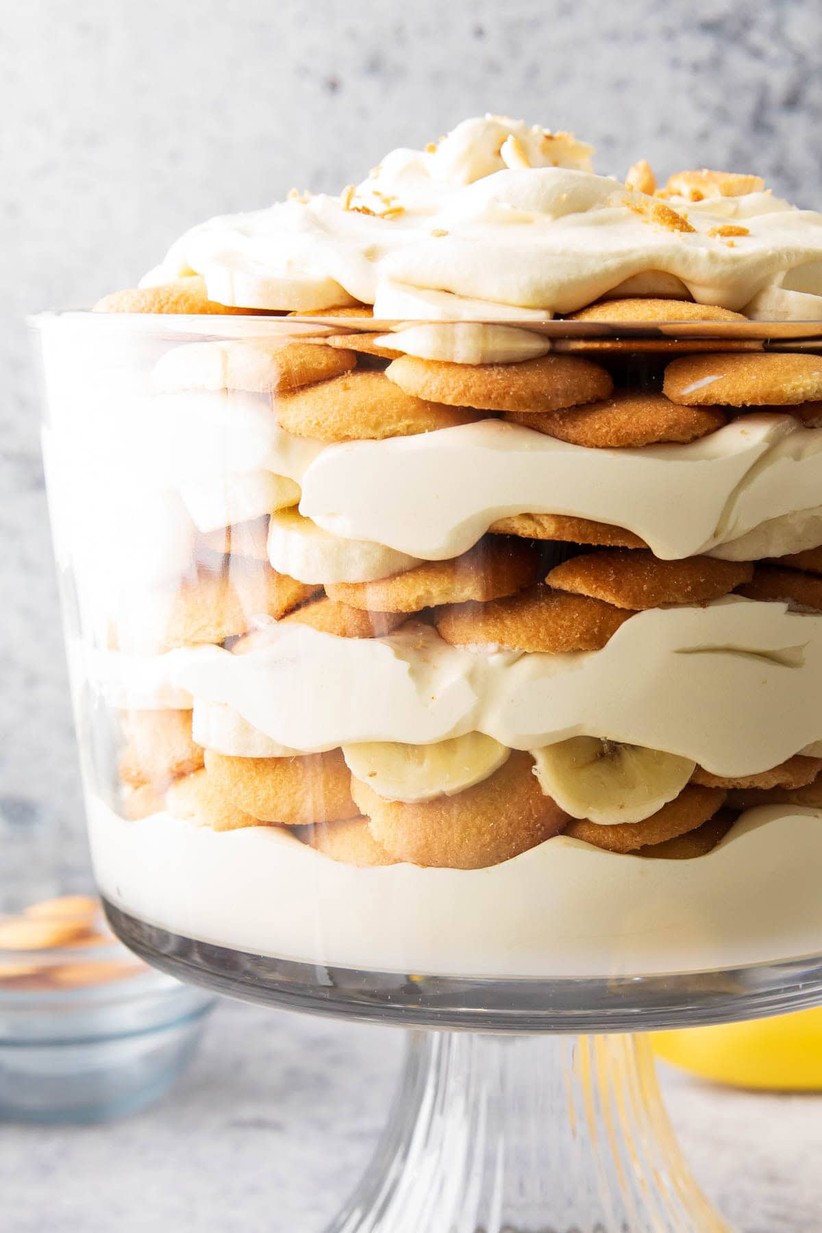 close up of this Easy Banana Pudding recipe to showcase fluffy layers of whipped topping, banana-infused pudding, and crispy Nilla wafers