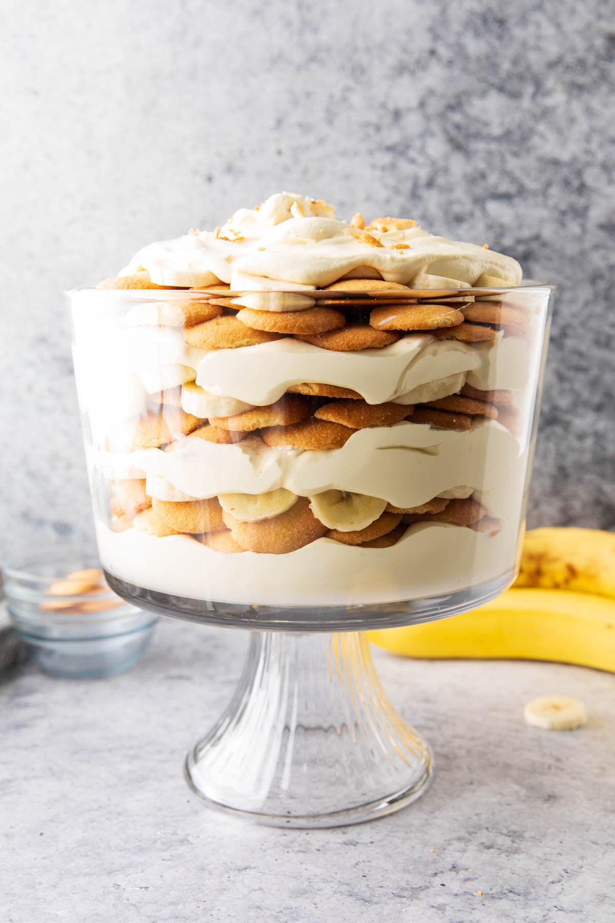 Ripe bananas, crunchy vanilla wafers, and whipped topping mixed with instant pudding mix layered in a glass bowl for this simple banana pudding recipe.