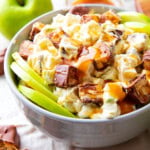 Snickers apple salad with Cool Whip served with Granny Smith apple slices and caramel apple topping