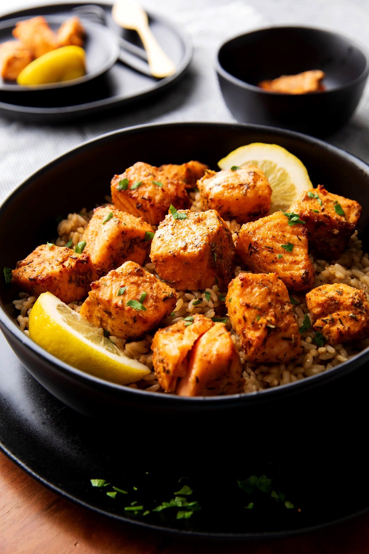 Air fryer blackened salmon bites are cooked until tender and flaky served over brown rice.