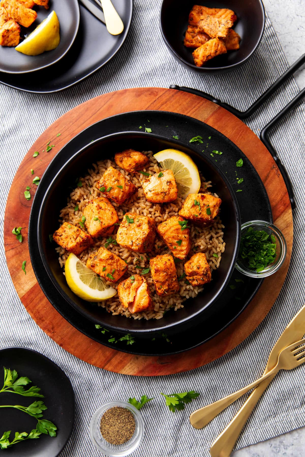Air Fryer blackened salmon bites are seasoned with blackened seasoning and served with lemon wedges.