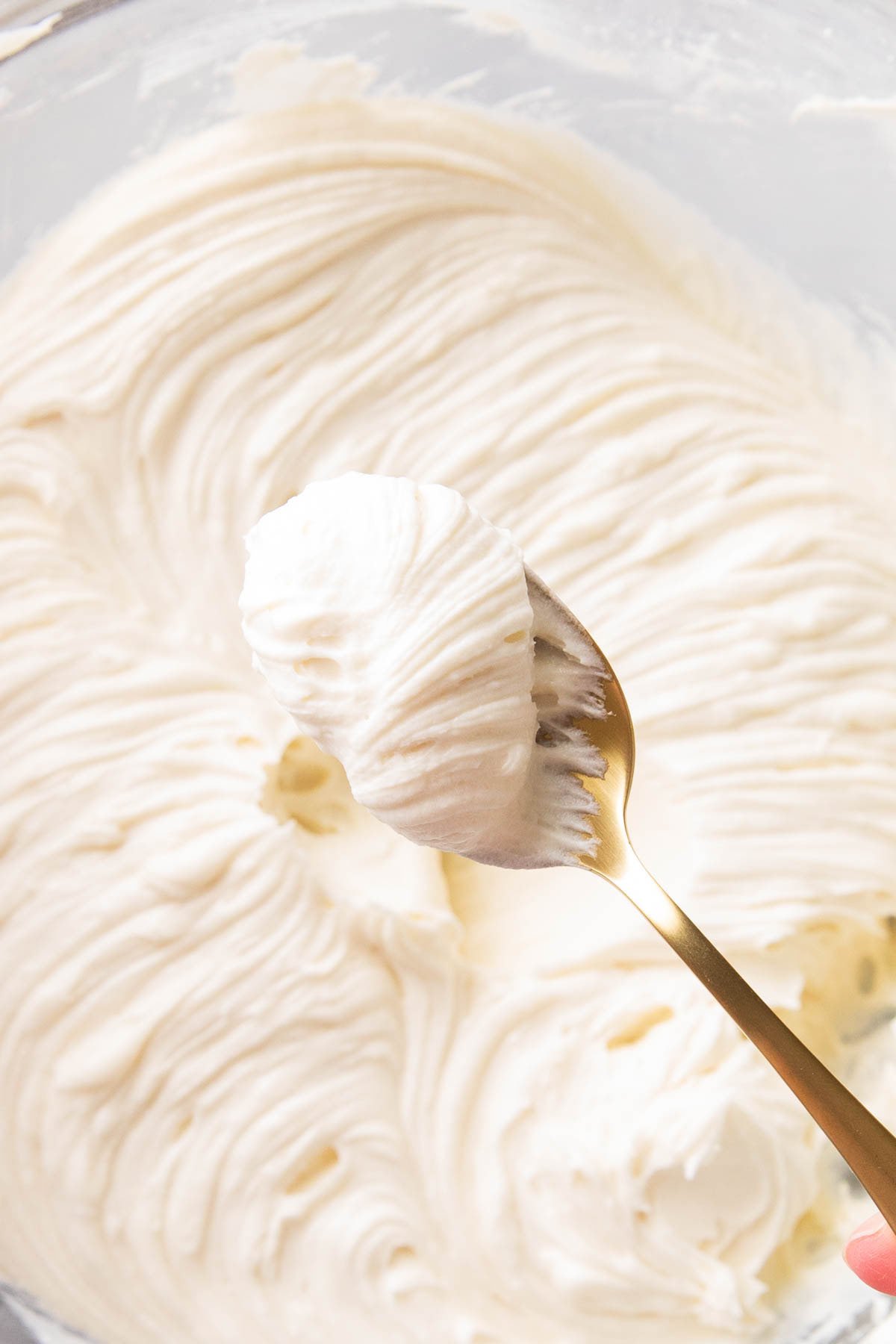 A spoon of thick rich and creamy Cream Cheese Frosting