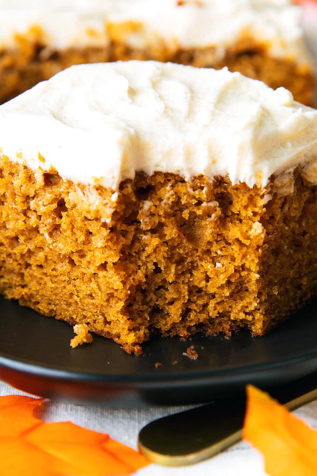 A slice of easy pumpkin cake with a bite taken out.