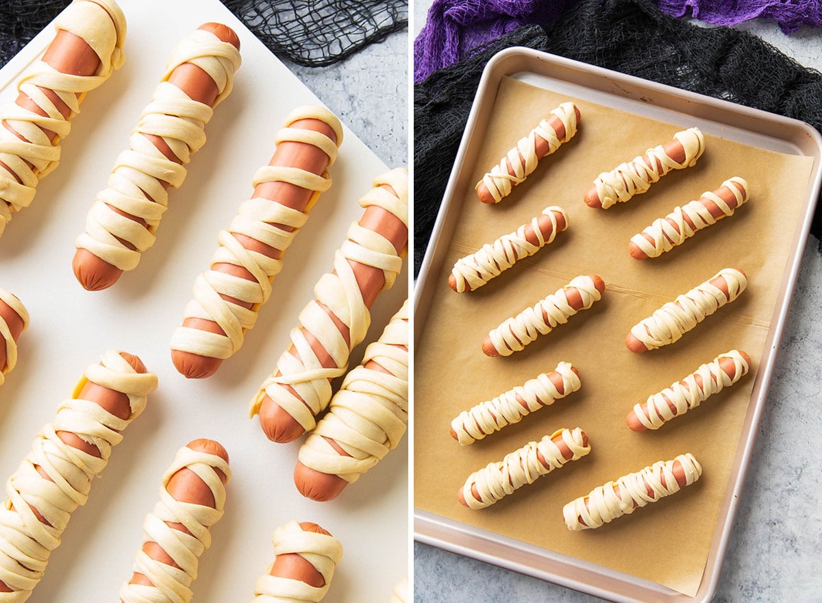 showing prepared Halloween appetizers laid out on a lined baking sheet ready to be baked