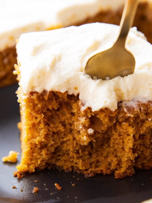 Close up of a fork digging into a slice of this pumpkin cake recipe