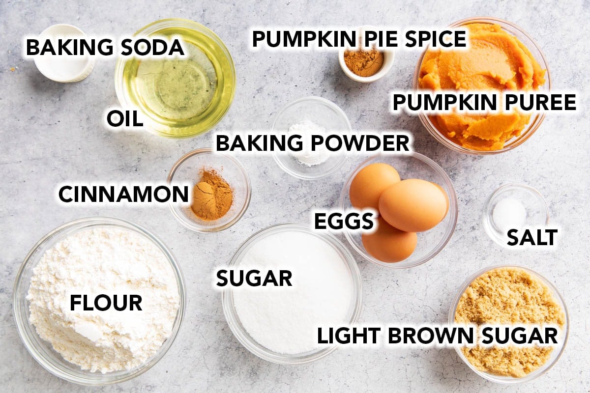Pumpkin Cake Recipe ingredients include flour, pumpkin, oil, sugar, brown sugar, pumpkin pie spice, cinnamon, and more.