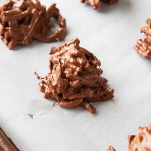 Haystack Cookies on parchment paper in the process of setting.