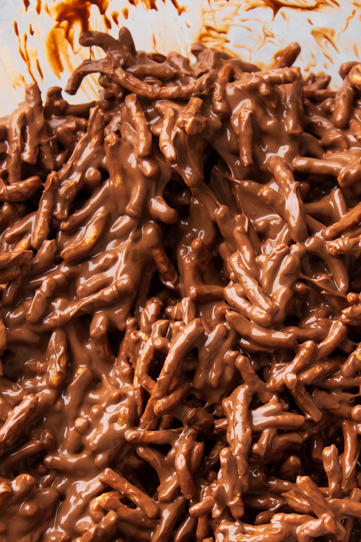 Melted chocolate, butterscotch, and peanut butter coating chow mein noodles to make this unbaked mixture.