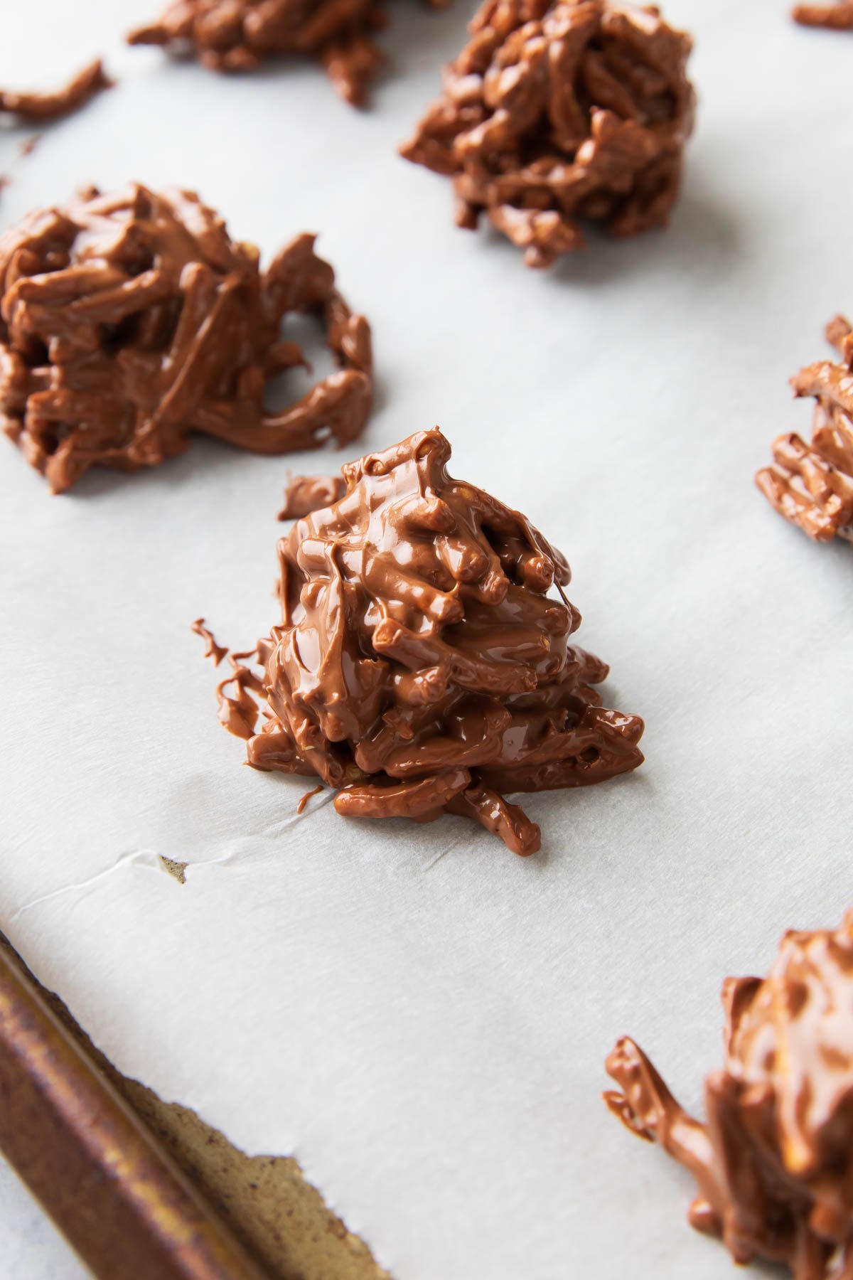 Close up of haystack cookies to show chocolate butterscotch mixture coating crunchy chow mien noodles.