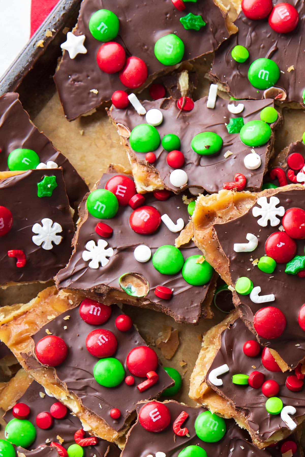 Close up of Christmas Crack in pieces on parchment paper