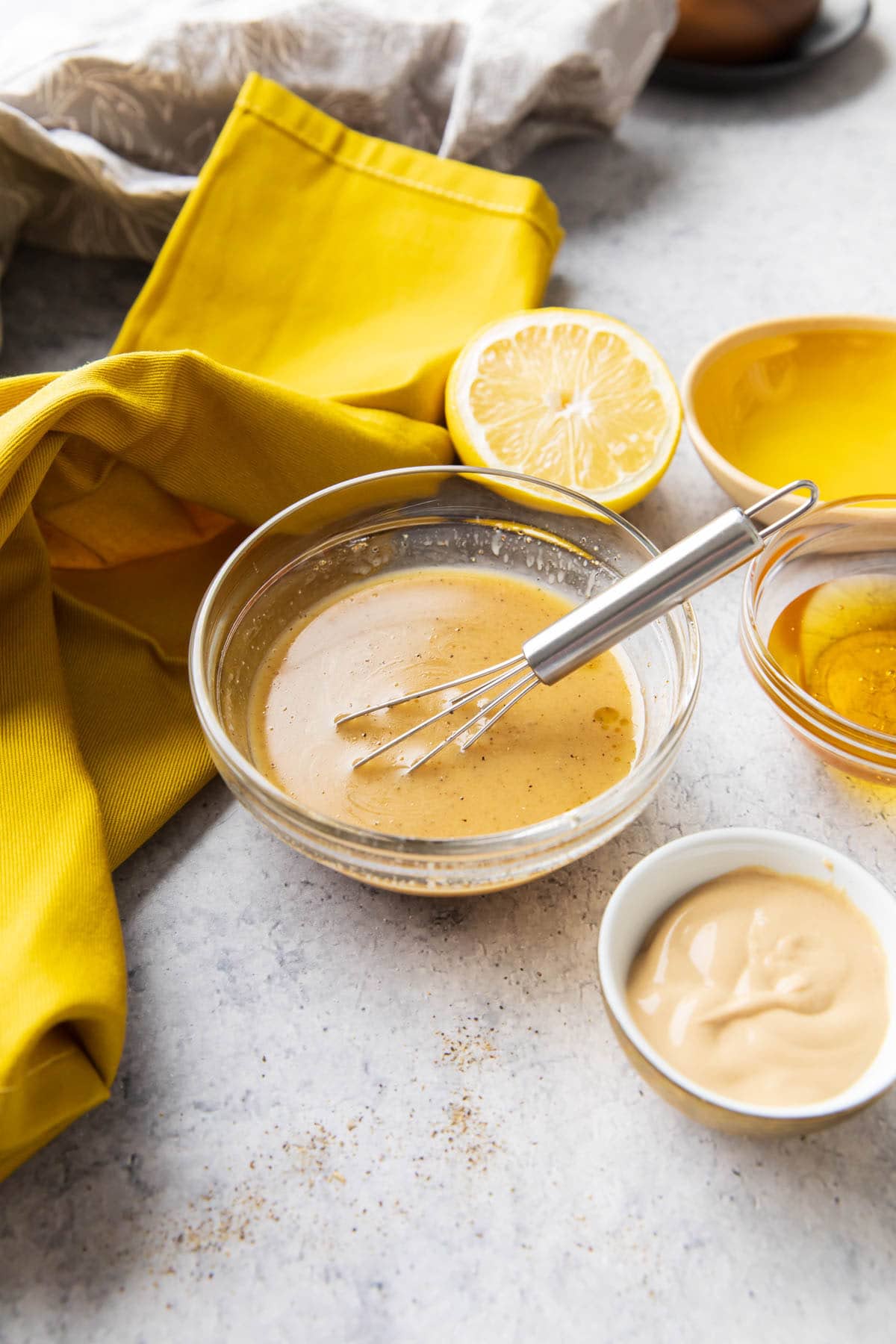 This salad dressing recipe shown with lemons and other ingredients