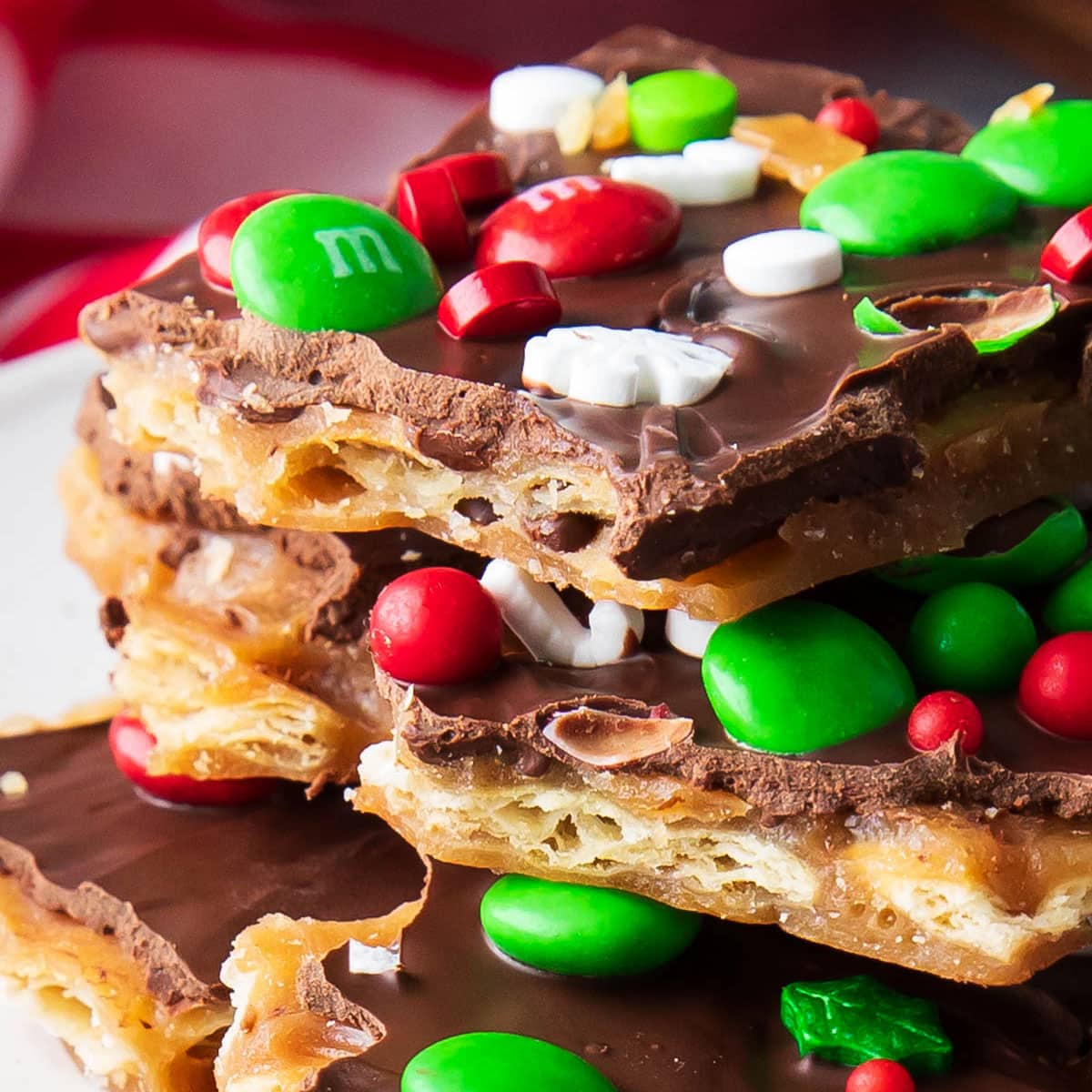 Stack of Christmas Crack on a plate featuring red and green Christmas M&M's