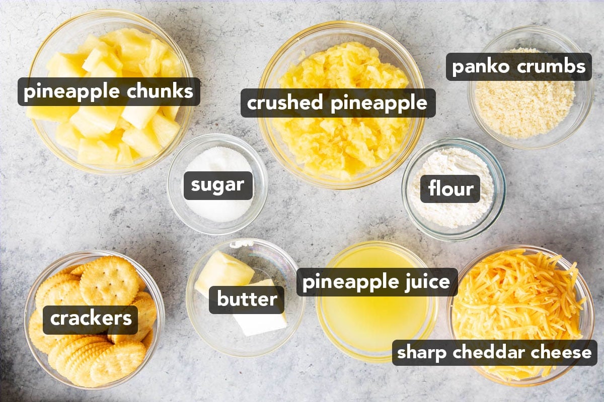 Pineapple casserole ingredients like pineapple chunks and crushed pineapple, sharp cheddar cheese, flour, butter, Ritz crackers, Panko crumbs, sugar, and pineapple juice measured into prep bowls