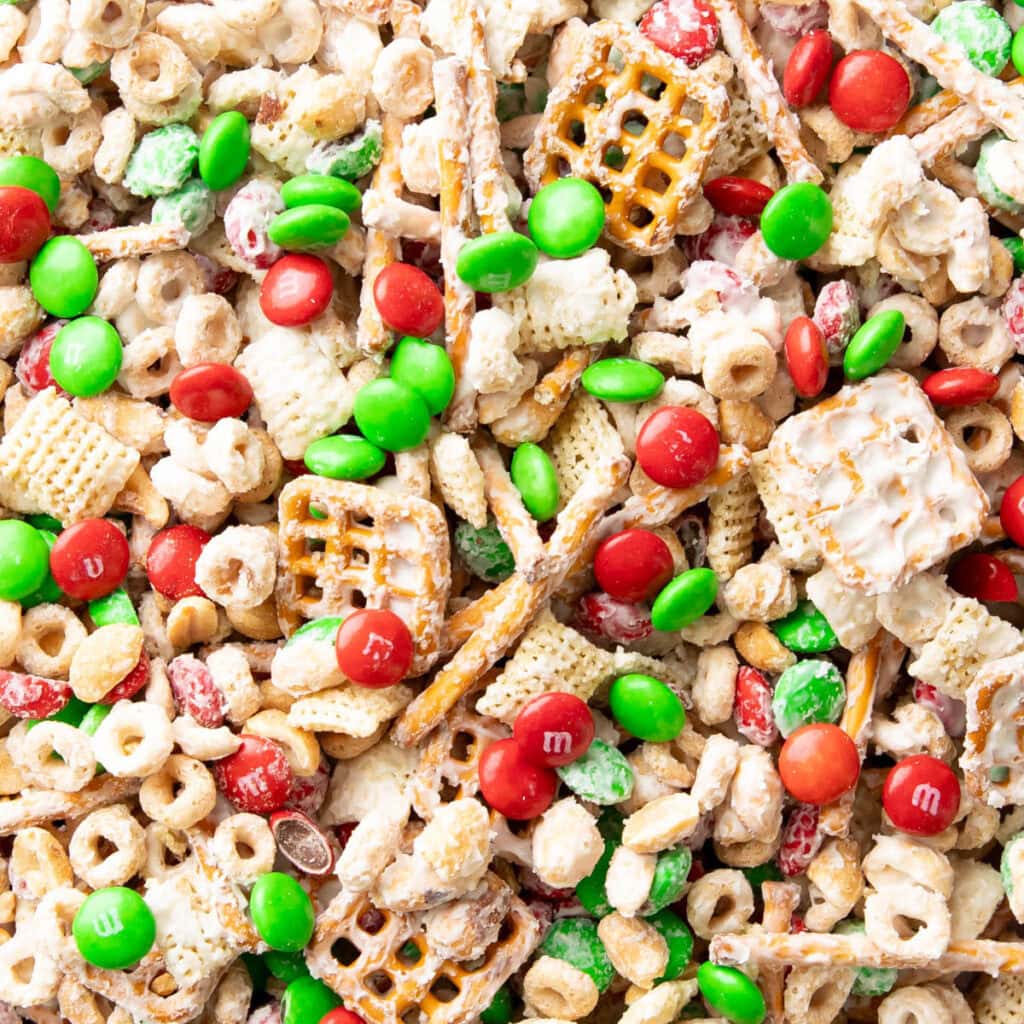 close up of reindeer chow recipe to show white chocolate covered chex mix and holiday candies