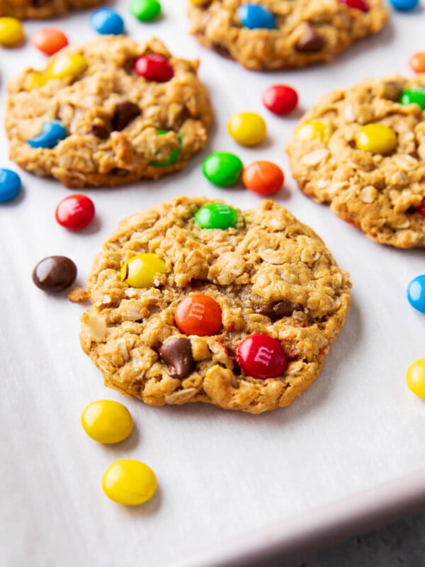 ngled photo of monster cookies with chewy oat texture, dotted with colorful M&M’s candies and chocolate chips.