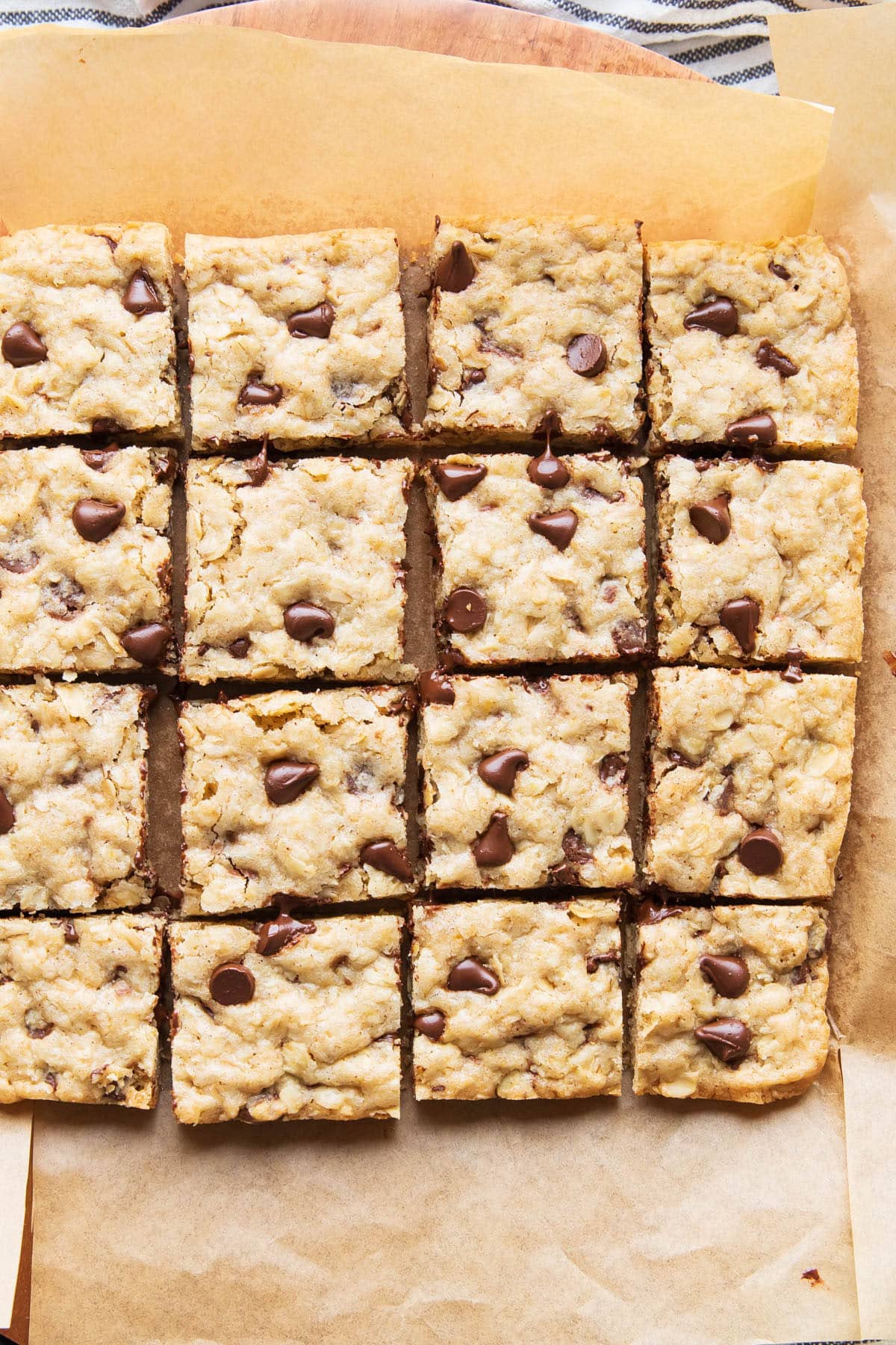 Overhead photo of neatly sliced oatmeal cookie bars on parchment paper