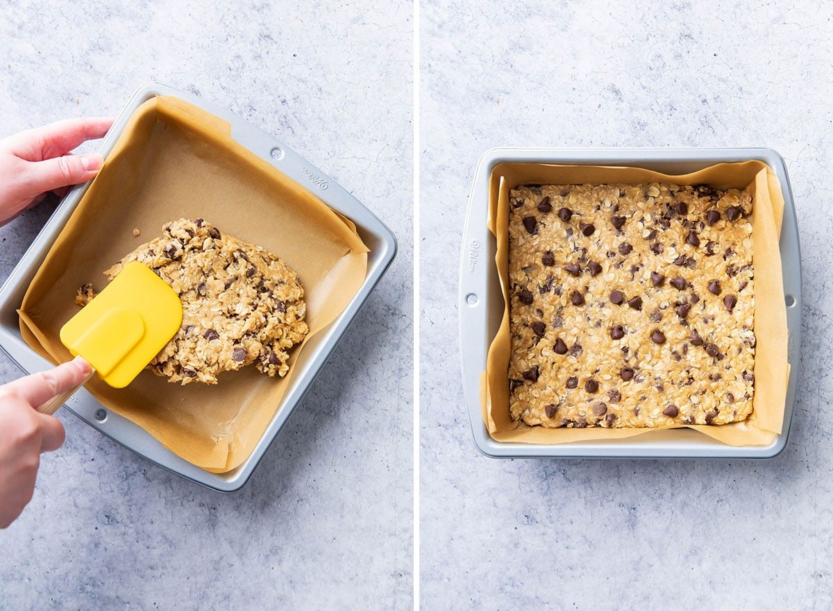 Using a spatula to press dough into an even layer in a lined baking pan before baking.