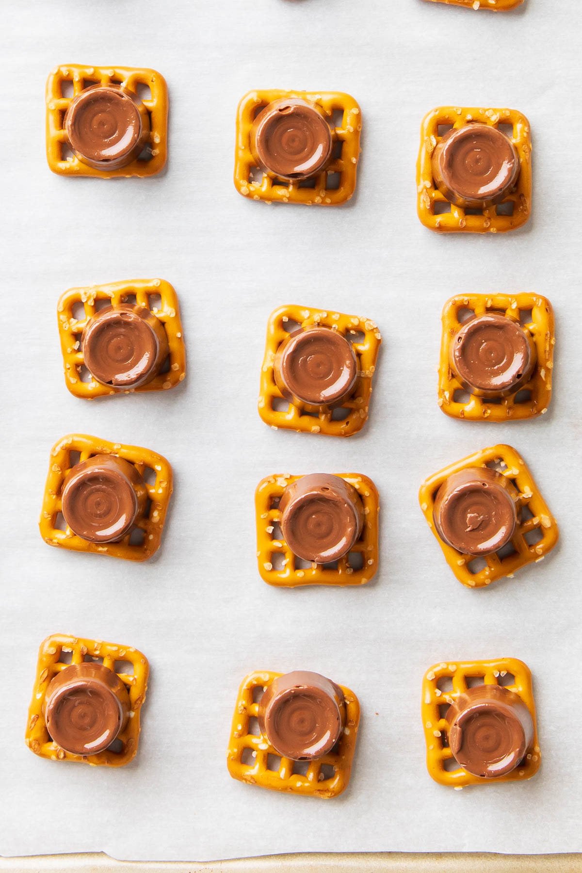 A photo showing how to make Rolo pretzel delights - oven-melted Rolo atop pretzels.