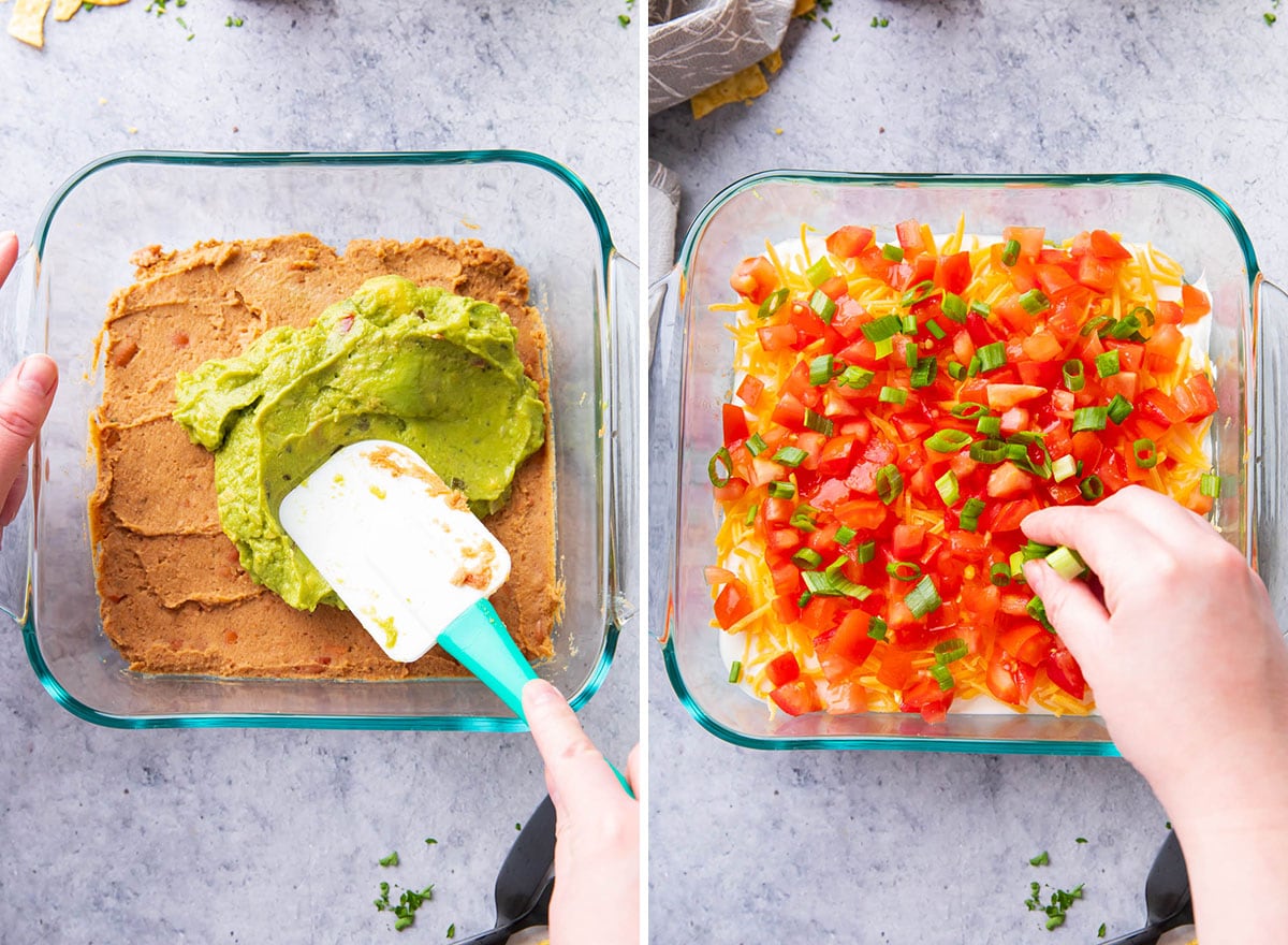 Spreading a layer of guacamole over refried beans, then cheese, tomatoes, and shredded Mexican blend cheese in a clear glass casserole dish