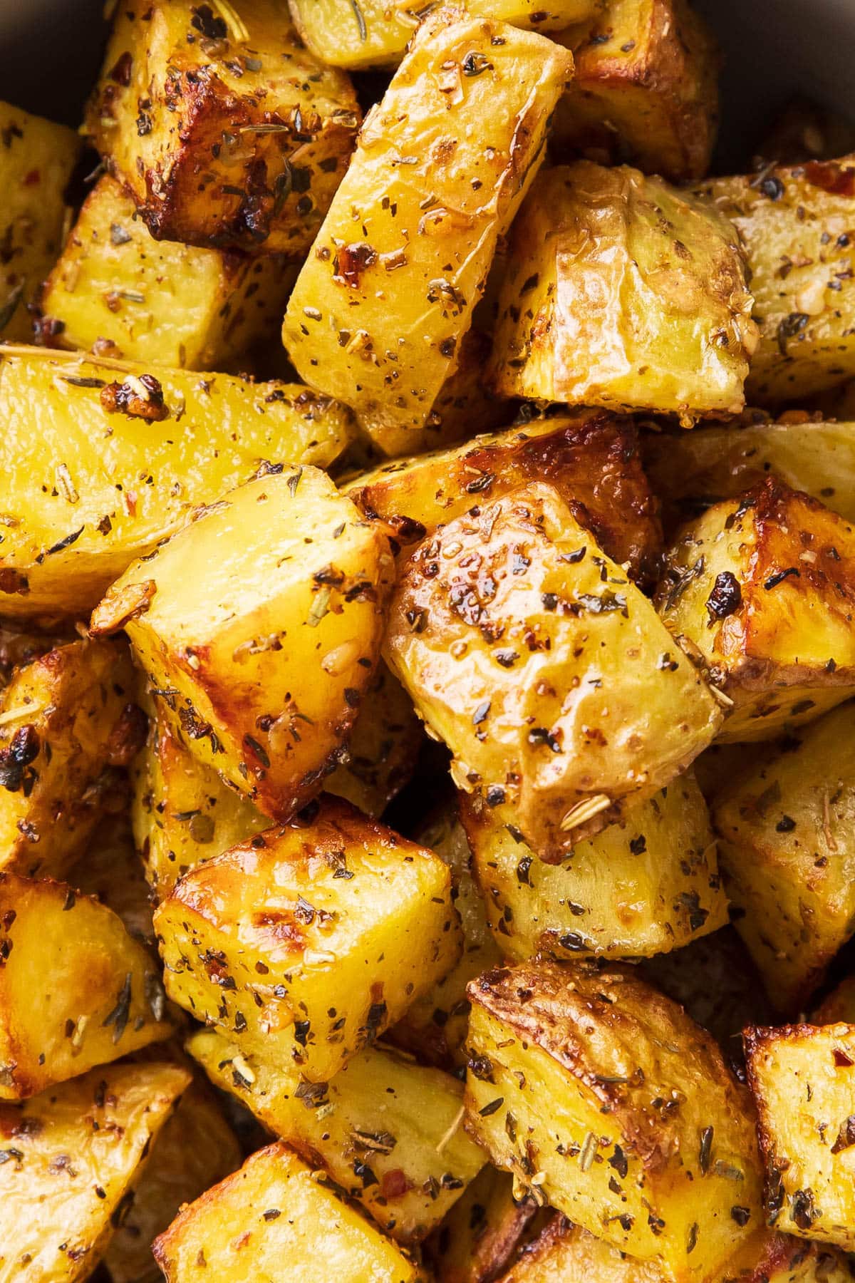 Close up of air fryer roast potatoes to show crisp, golden brown edges