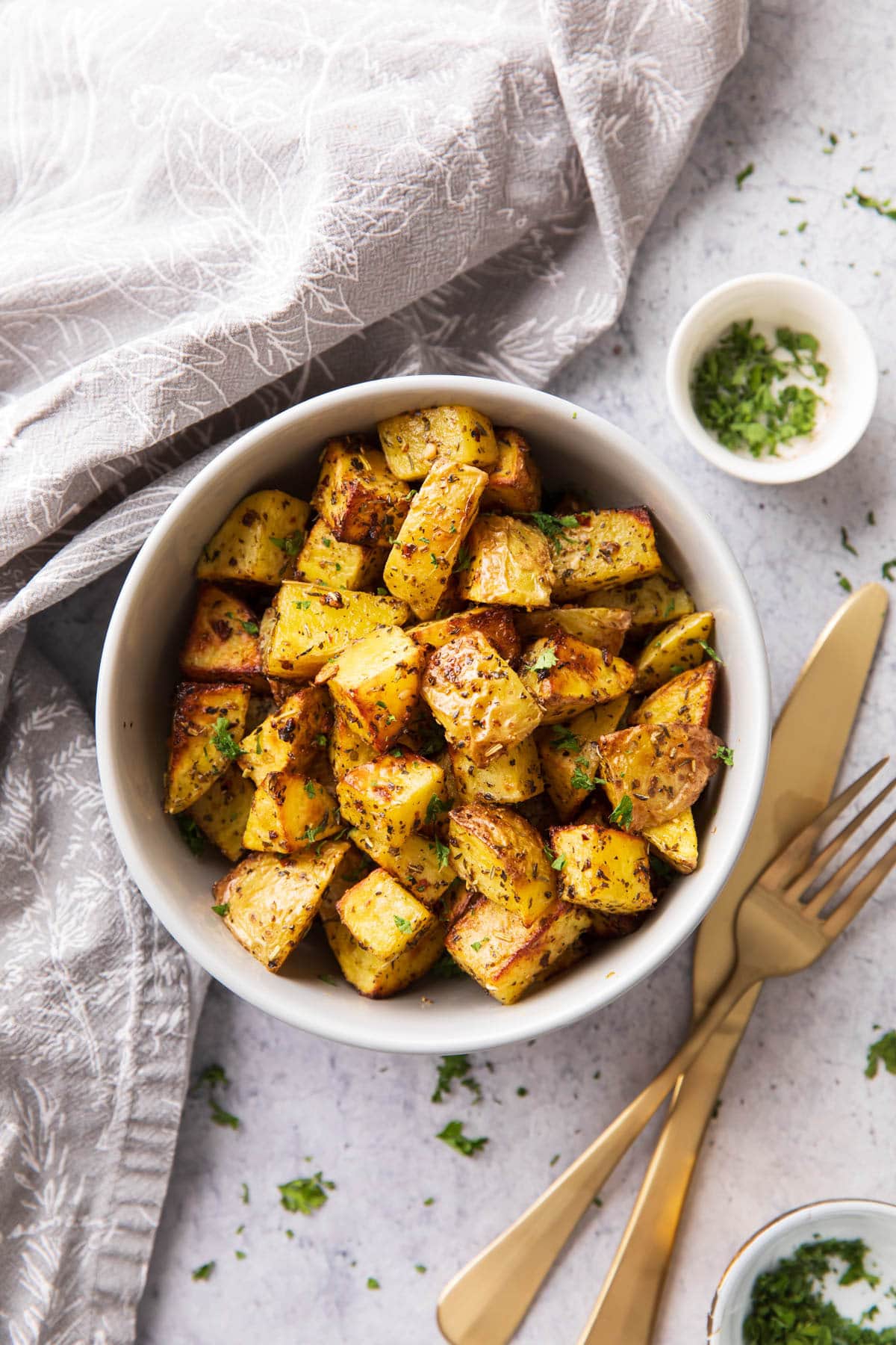 Serving bowl filled with this recipe served with garnish and utensils