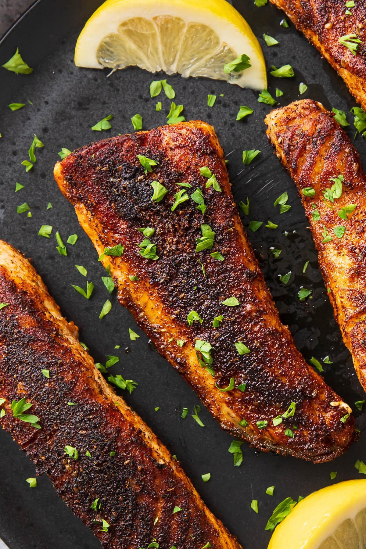 Close up of Blackened Salmon to show perfectly crisped cajun seasoning crust on tender salmon