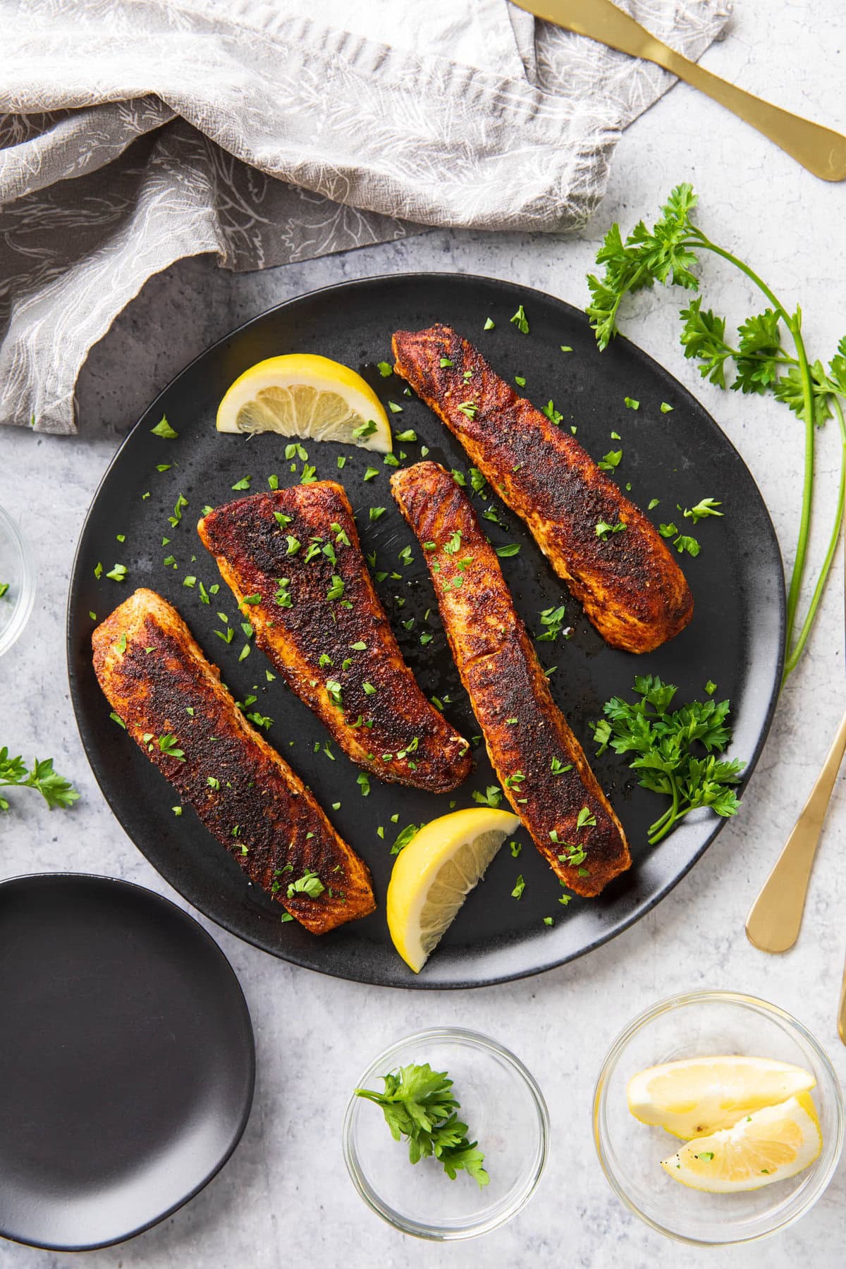 Serving this recipe for Blackened Salmon with fresh garnish and lemon.