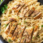 This chicken fettuccine Alfredo recipe in a skillet topped with roasted herby chicken, velvety creamy Alfredo sauce, and oodles of fettuccine pasta.