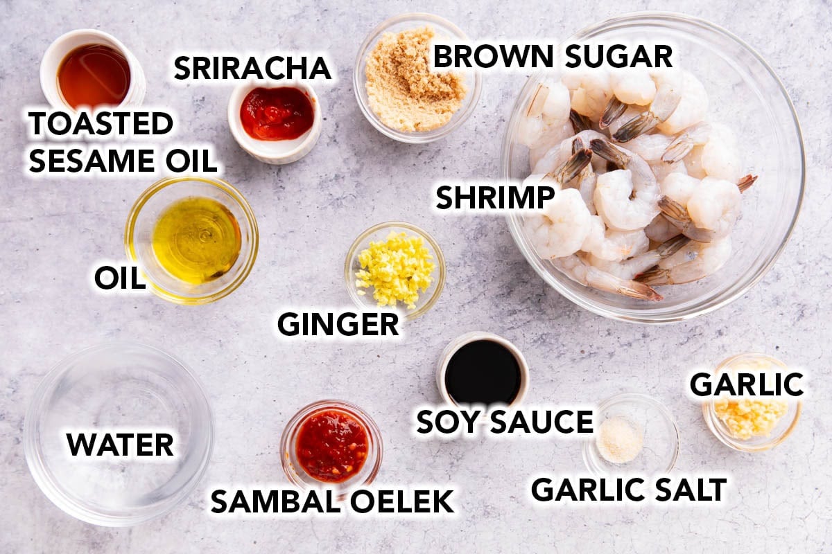 Asian Garlic Shrimp ingredients - raw shrimp, soy sauce, garlic, garlic salt, oil, toasted sesame oil, ginger, brown sugar, water, sambal oelek chili sauce, and sriracha.